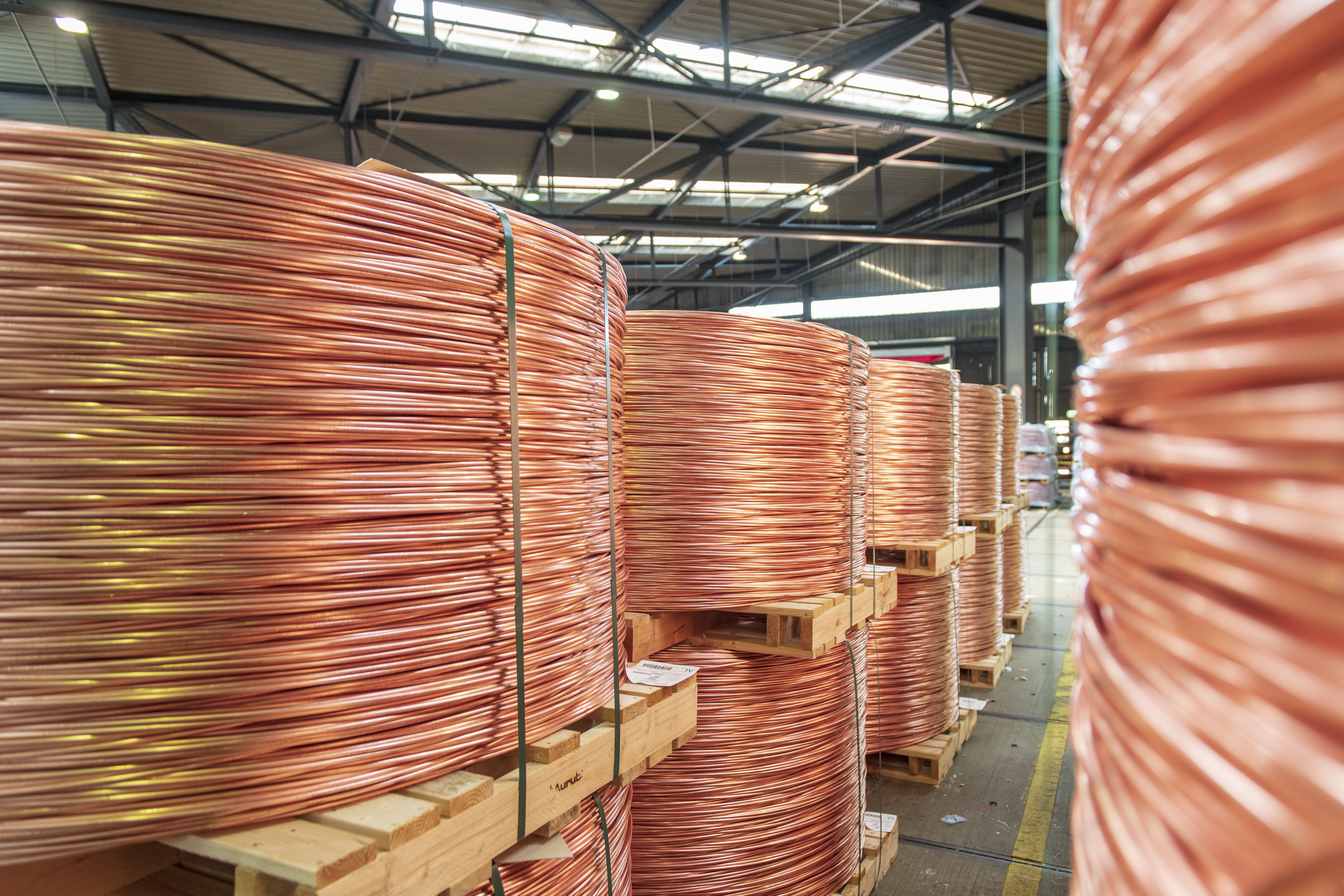 Coils of electrolytic copper wire rods inside industrial storage yard